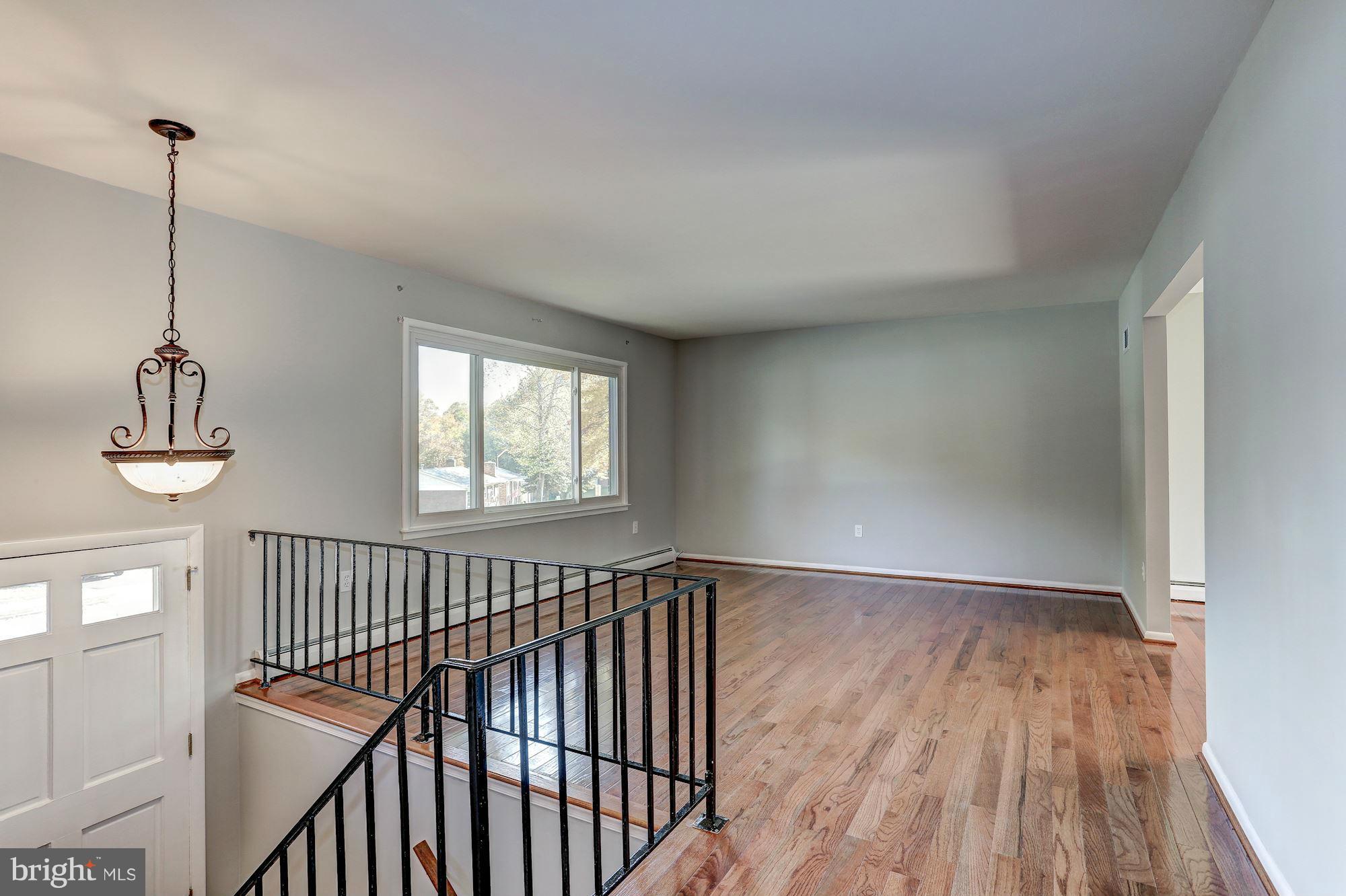 13818 Gilbert Road Woodbridge, VA 22193 - Photo 4 of 30 a view of hallway with wooden floor