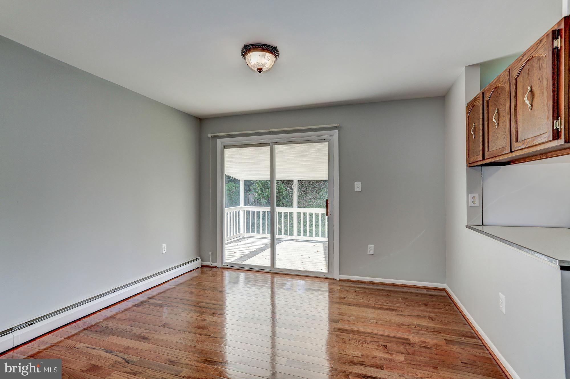 13818 Gilbert Road Woodbridge, VA 22193 - Photo 8 of 30 wooden floor in an empty room with a window