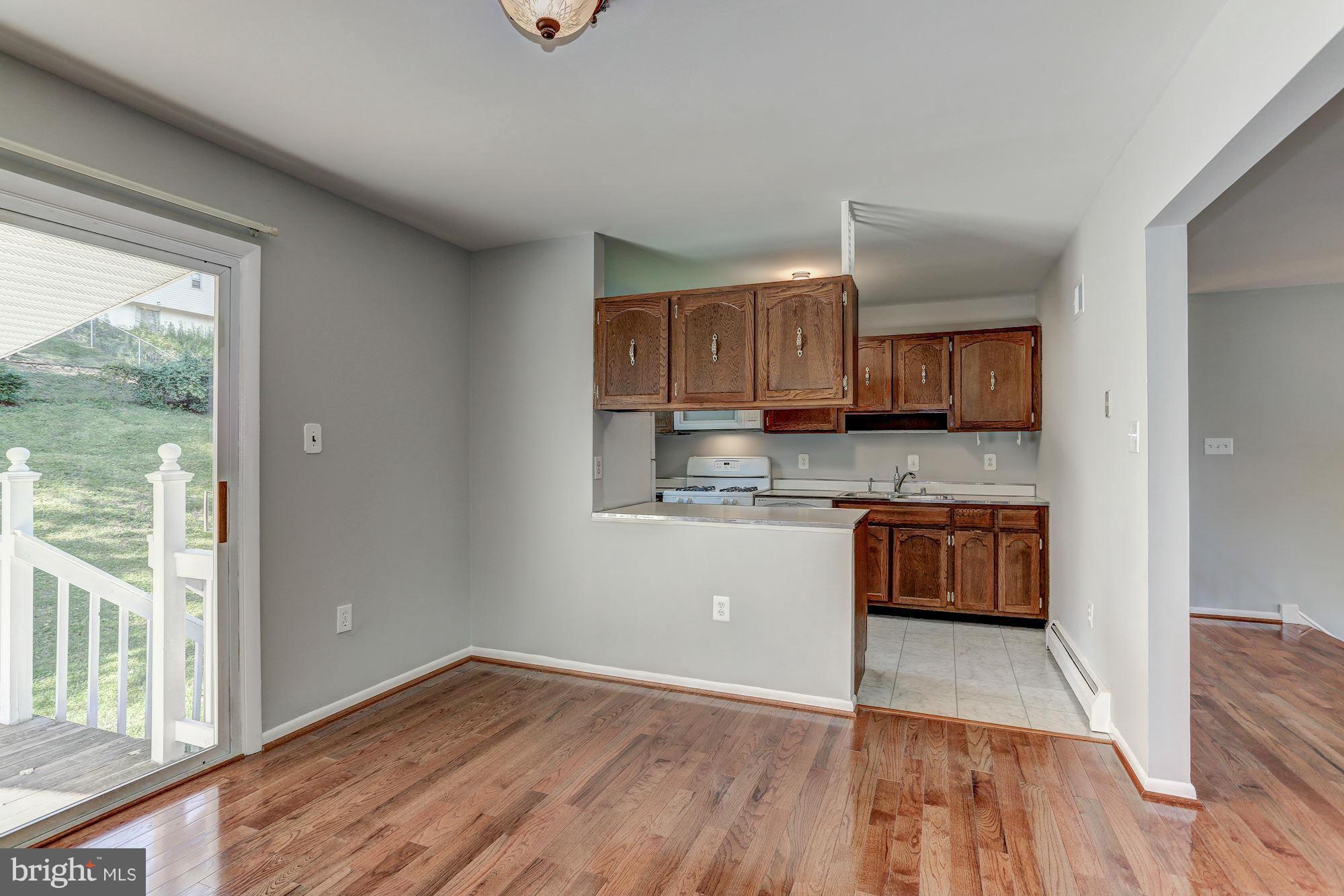 13818 Gilbert Road Woodbridge, VA 22193 - Photo 9 of 30 a kitchen with stainless steel appliances granite countertop a stove a sink and a refrigerator