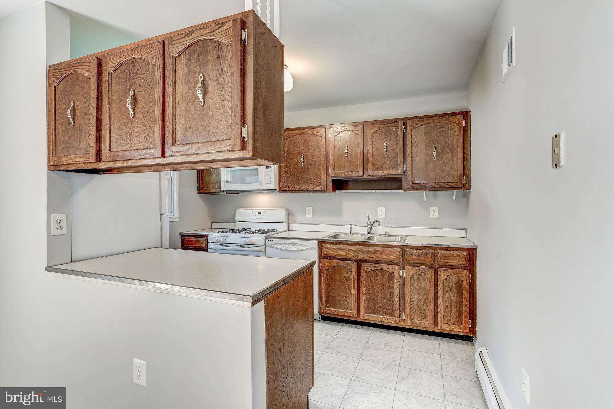 13818 Gilbert Road Woodbridge, VA 22193 - Photo 10 of 30 a kitchen with stainless steel appliances granite countertop a sink and a stove