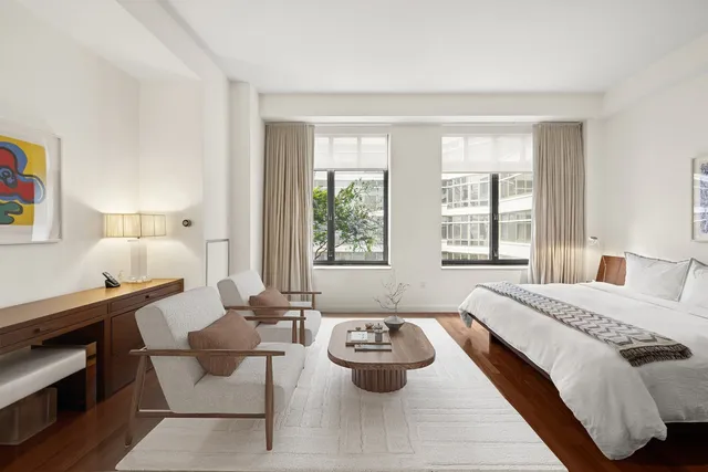 a spacious bedroom with a bed and a window