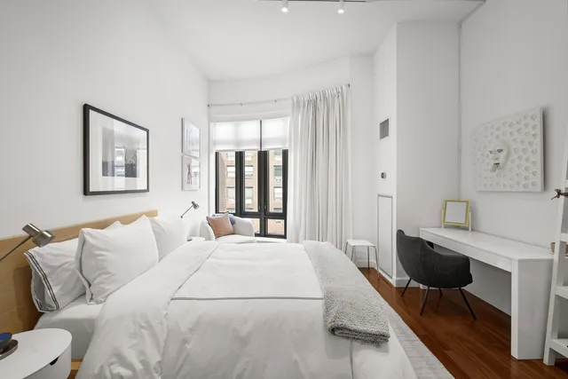 a large bedroom with a bed and a table