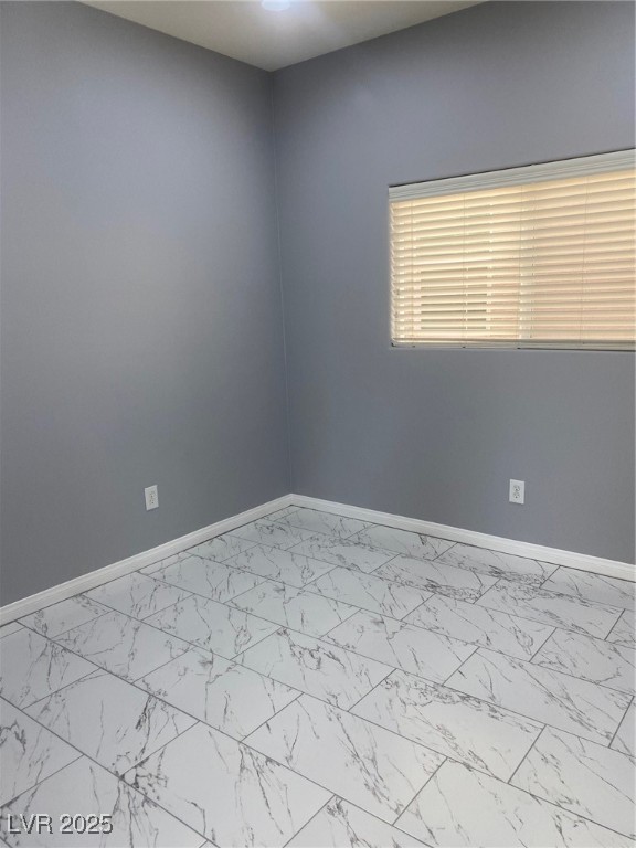 9541 Vast Valley Avenue Las Vegas, NV 89148 - Photo 27 of 32 Spare room with baseboards and light marble finish flooring