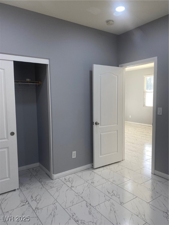 9541 Vast Valley Avenue Las Vegas, NV 89148 - Photo 28 of 32 Unfurnished bedroom featuring light marble finish floors and a closet