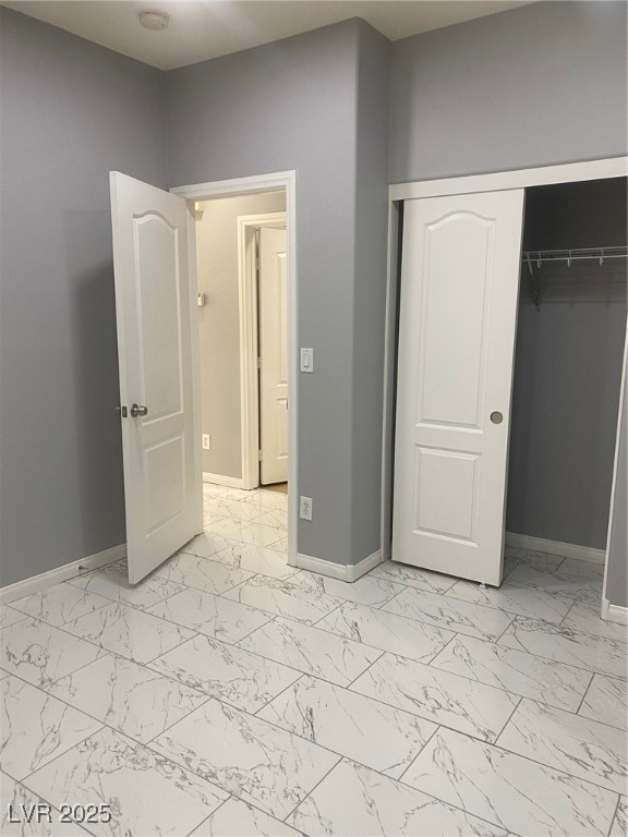 9541 Vast Valley Avenue Las Vegas, NV 89148 - Photo 30 of 32 Unfurnished bedroom with light marble finish flooring and a closet