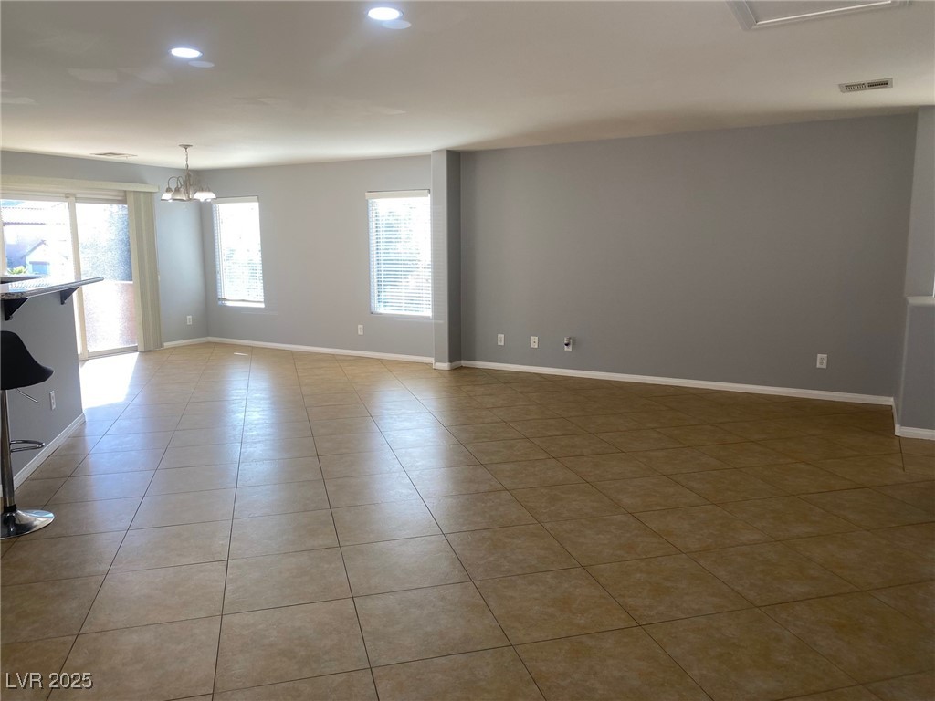 9541 Vast Valley Avenue Las Vegas, NV 89148 - Photo 6 of 32 Unfurnished room with recessed lighting, light tile patterned flooring, and a chandelier