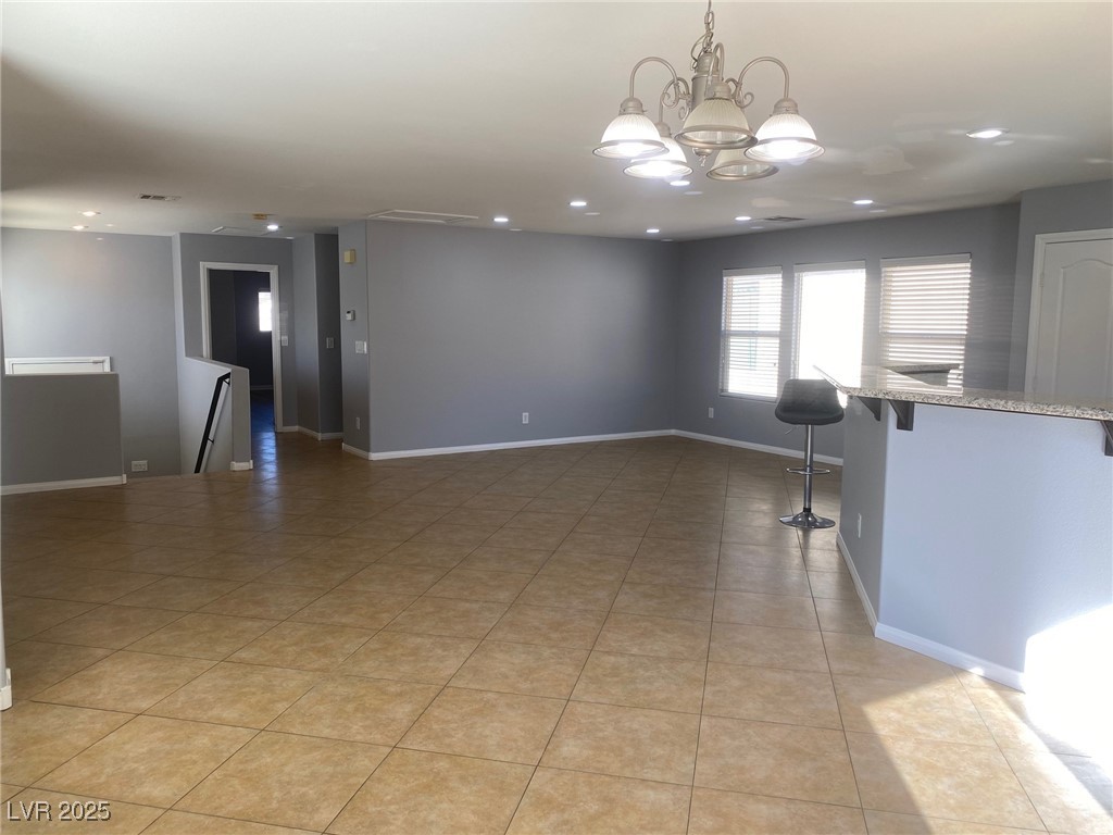 9541 Vast Valley Avenue Las Vegas, NV 89148 - Photo 7 of 32 Empty room with a chandelier and recessed lighting