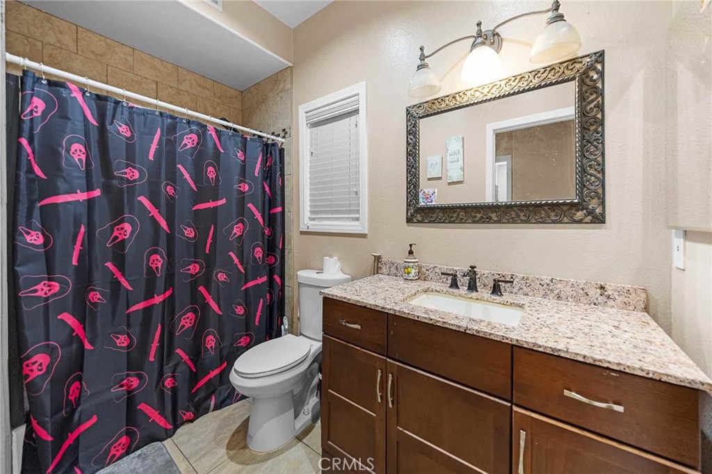 32245 Refa Street Wildomar, CA 92595 - Photo 15 of 35 a bathroom with a granite countertop bathtub sink vanity mirror and toilet