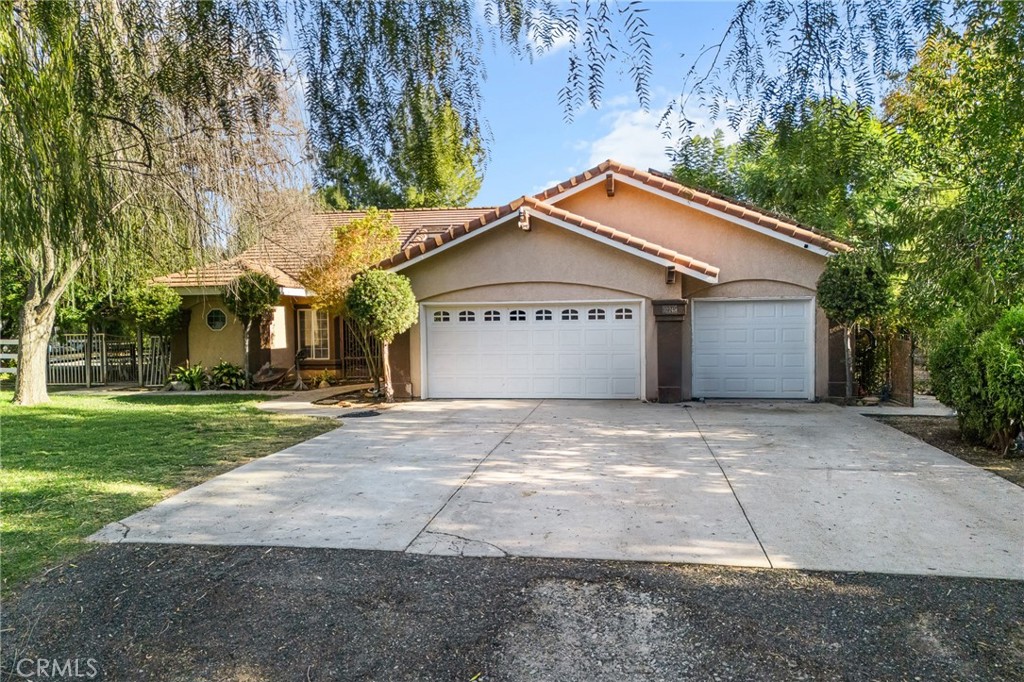 32245 Refa Street Wildomar, CA 92595 - Photo 35 of 35 a front view of a house with a yard and garage