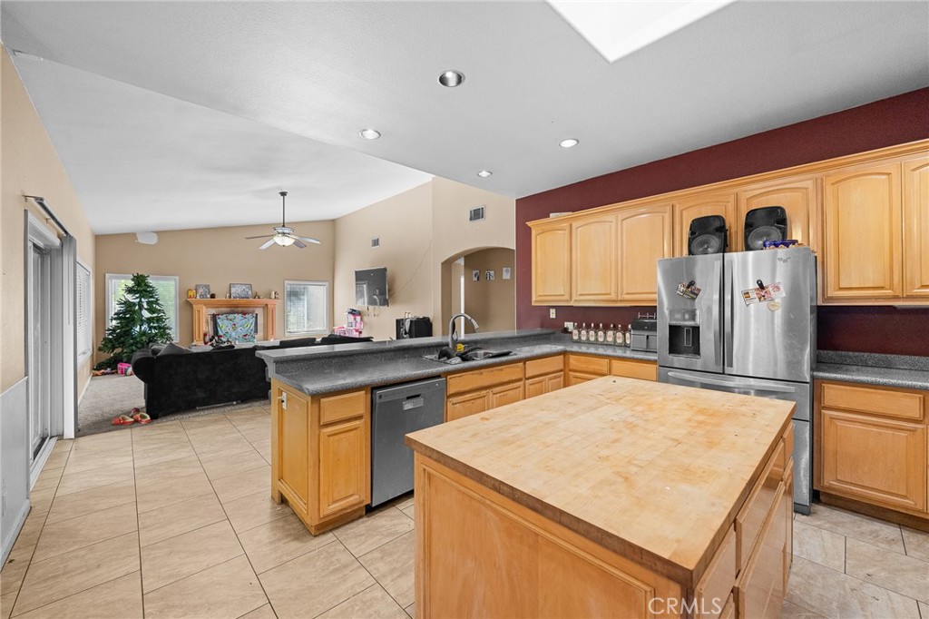 32245 Refa Street Wildomar, CA 92595 - Photo 8 of 35 a large kitchen with stainless steel appliances a stove a refrigerator a oven and white cabinets