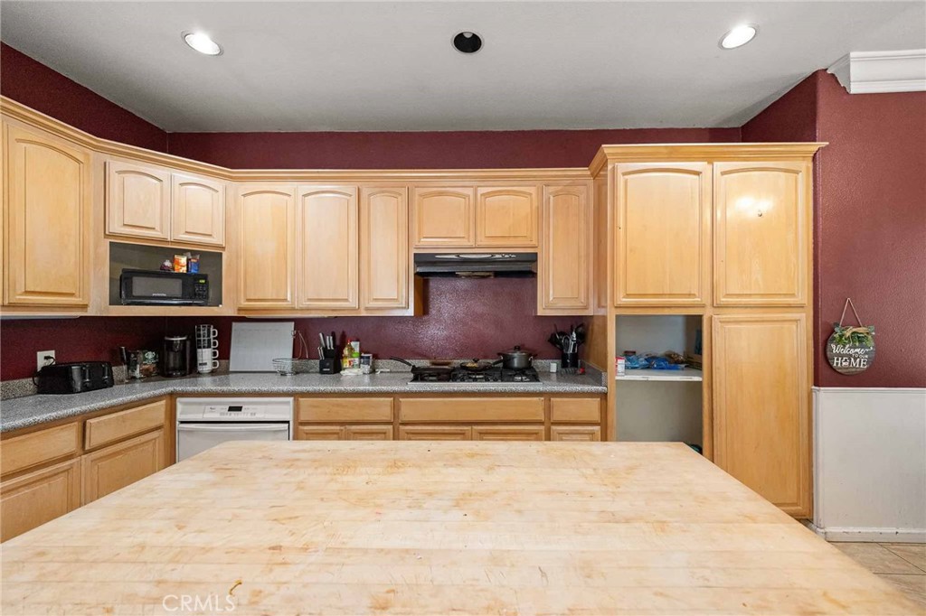 32245 Refa Street Wildomar, CA 92595 - Photo 9 of 35 a kitchen with stainless steel appliances granite countertop a refrigerator sink and cabinets