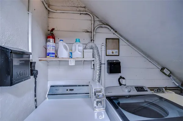 a kitchen with stainless steel appliances granite countertop a sink and wooden cabinets