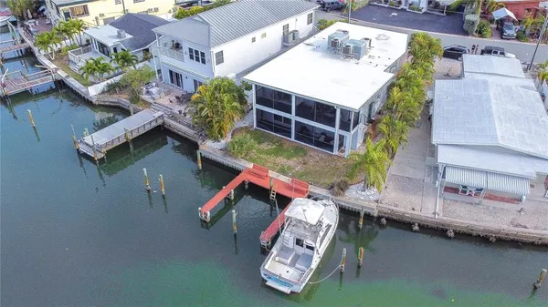 an aerial view of a house with pool patio and outdoor seating