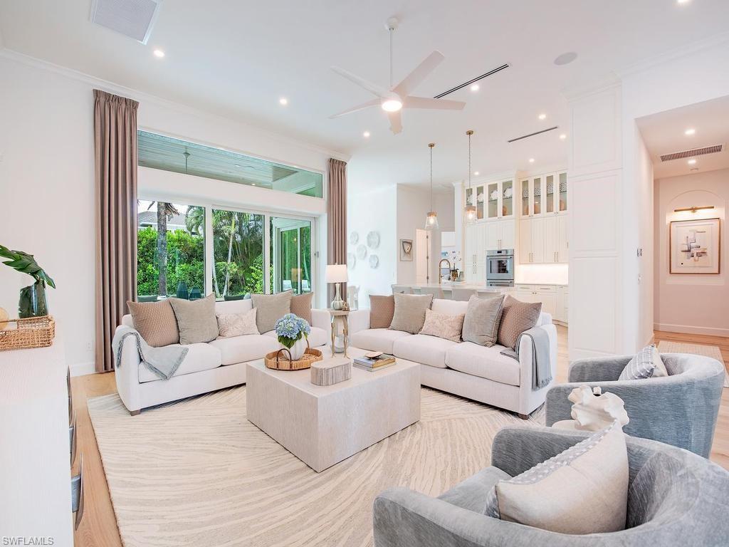 2363 Crayton Road Naples, FL 34103 - Photo 12 of 30 Expansive living area featuring light wood-finish flooring, a large area rug, and recessed ceiling lighting