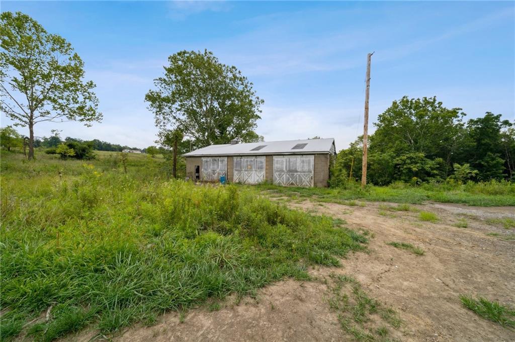 1663 Banning Road Dawson, PA 15428 - Photo 5 of 15 a front view of a house with garden