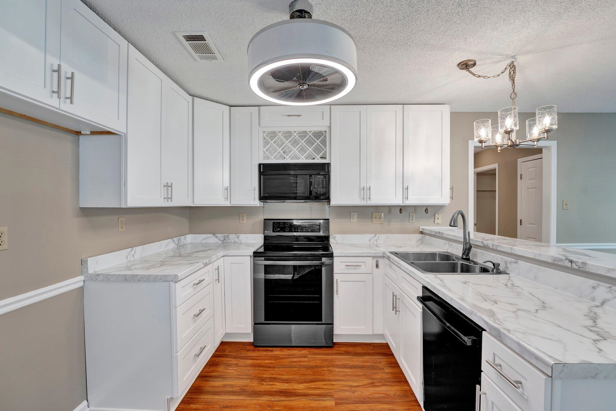 3735 Haynes Road Bartlett, TN 38133 - Photo 7 of 38 Kitchen was renovated with new cabinets, lighting and LVT flooring.