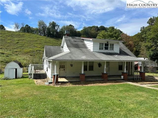 a view of a kitchen with a sink cabinet and windows