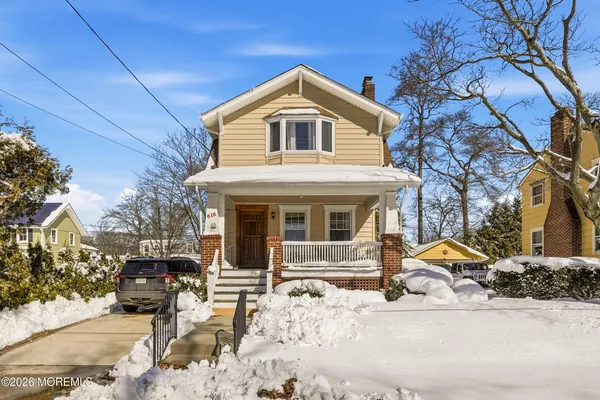 a view of a house with a yard covered in snow