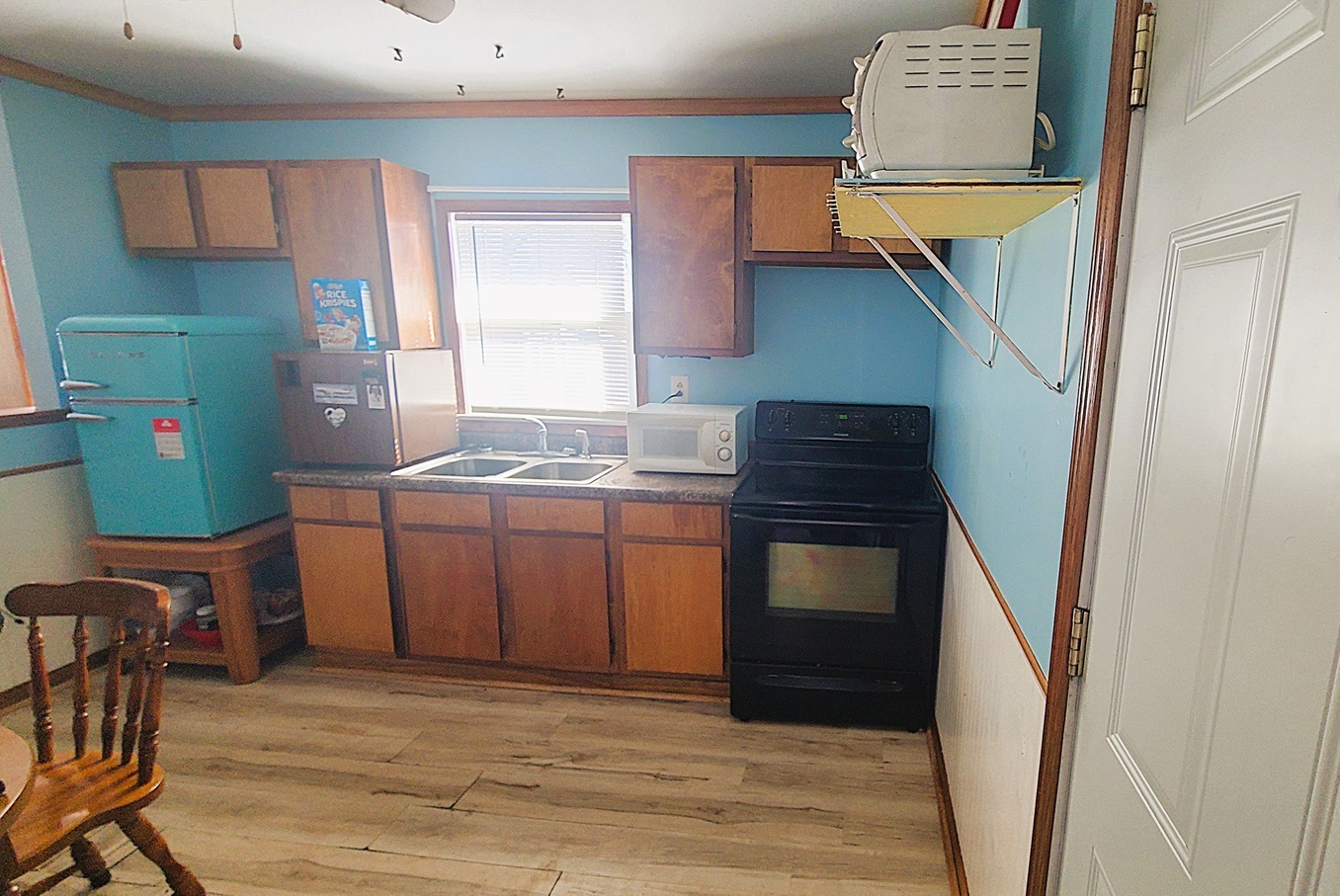 1106 Steinman Street Dixon, IL 61021 - Photo 7 of 14 a kitchen with a refrigerator and a stove top oven