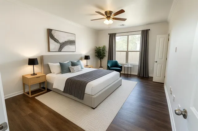 a bedroom with a large bed a chandelier and windows