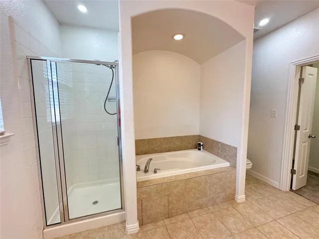 a bathroom with a tub and shower