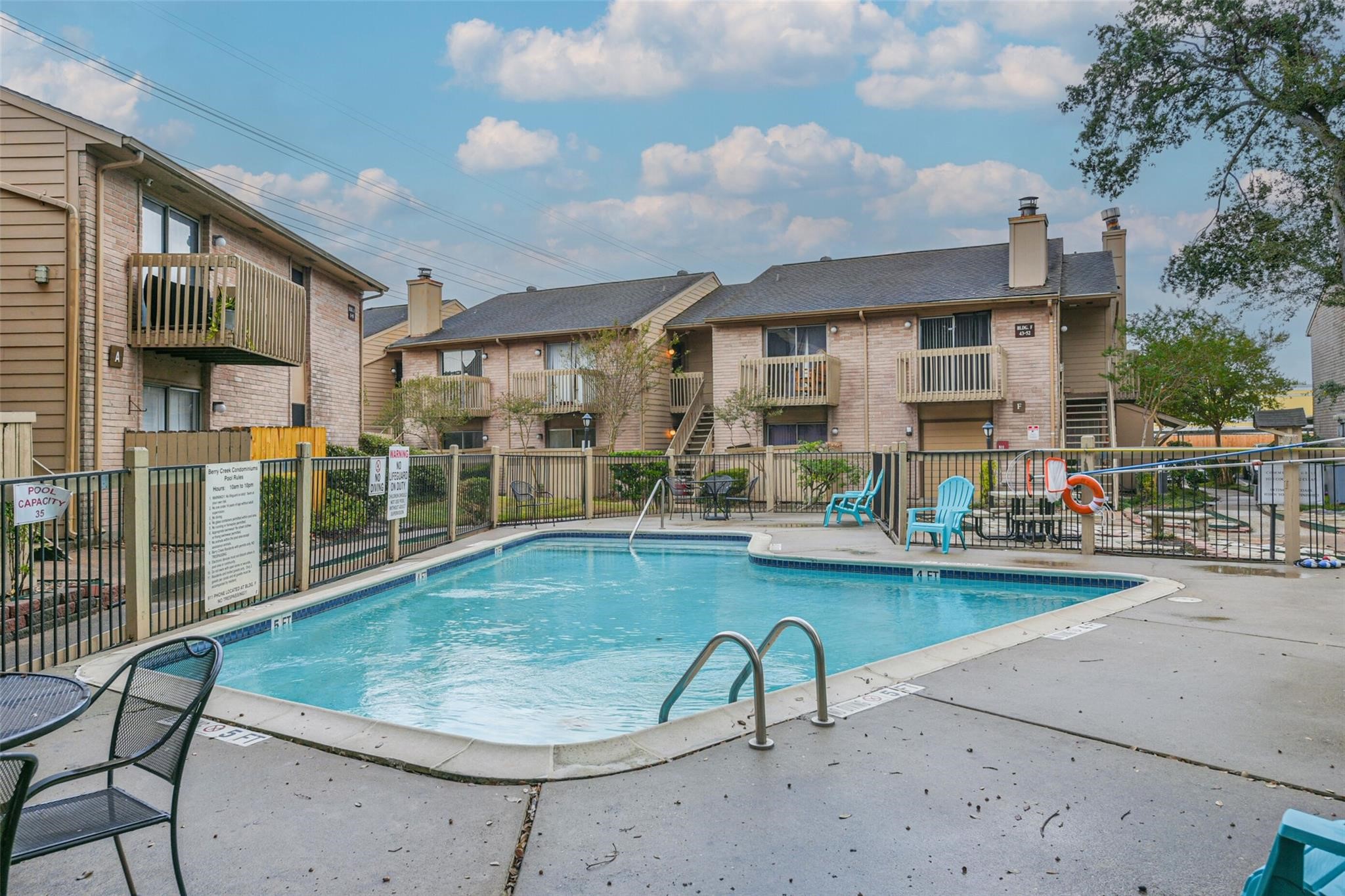 a view of a swimming pool with outdoor seating