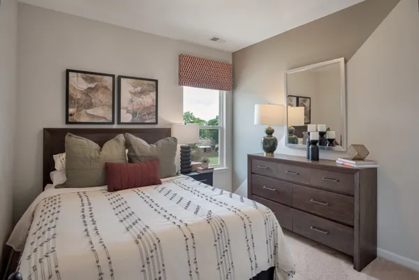 a bedroom with a bed and window
