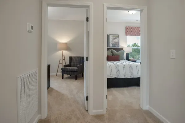 a bed sitting in a bedroom next to a window