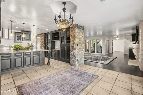 a bathroom with a granite countertop sink a large mirror and a window