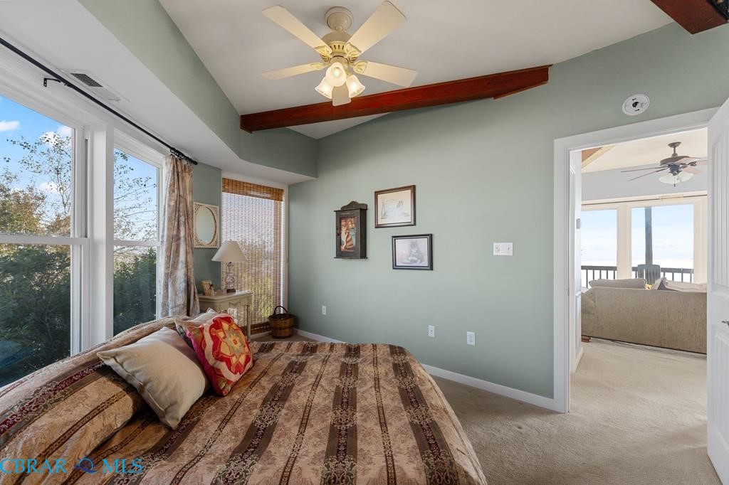 24 River Road Lottsburg, VA 22511 - Photo 17 of 35 a bedroom with a bed and a chandelier