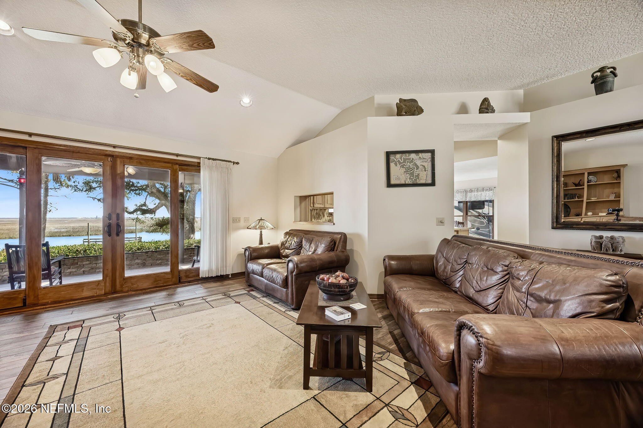 97146 Pirates Point Road Yulee, FL 32097 - Photo 10 of 74 a living room with furniture large window and flat screen tv