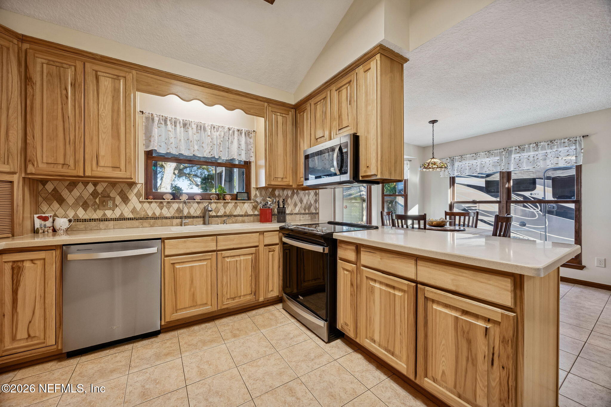 97146 Pirates Point Road Yulee, FL 32097 - Photo 17 of 74 a kitchen with sink cabinets and window