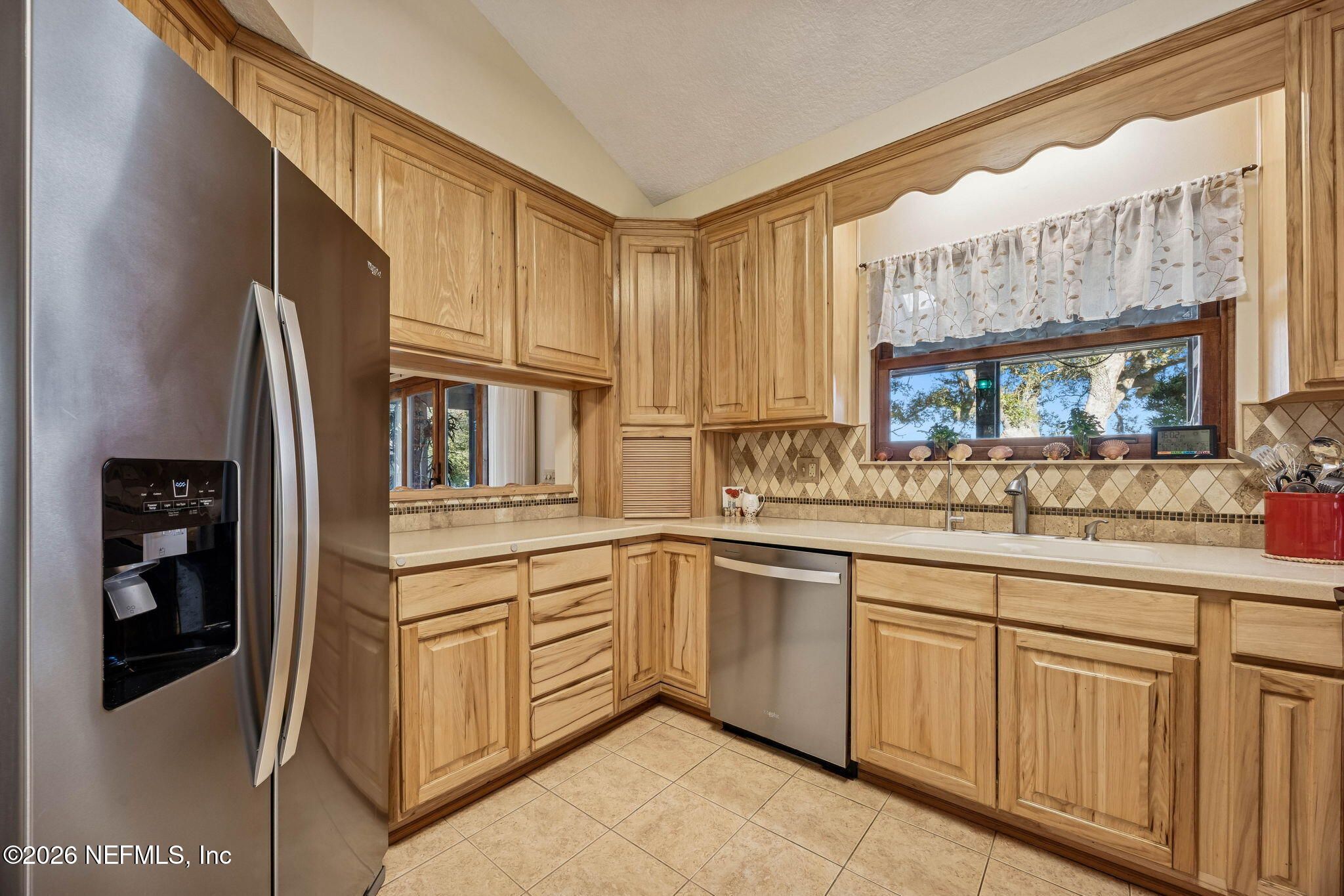 97146 Pirates Point Road Yulee, FL 32097 - Photo 19 of 74 a kitchen with cabinets and outdoor view