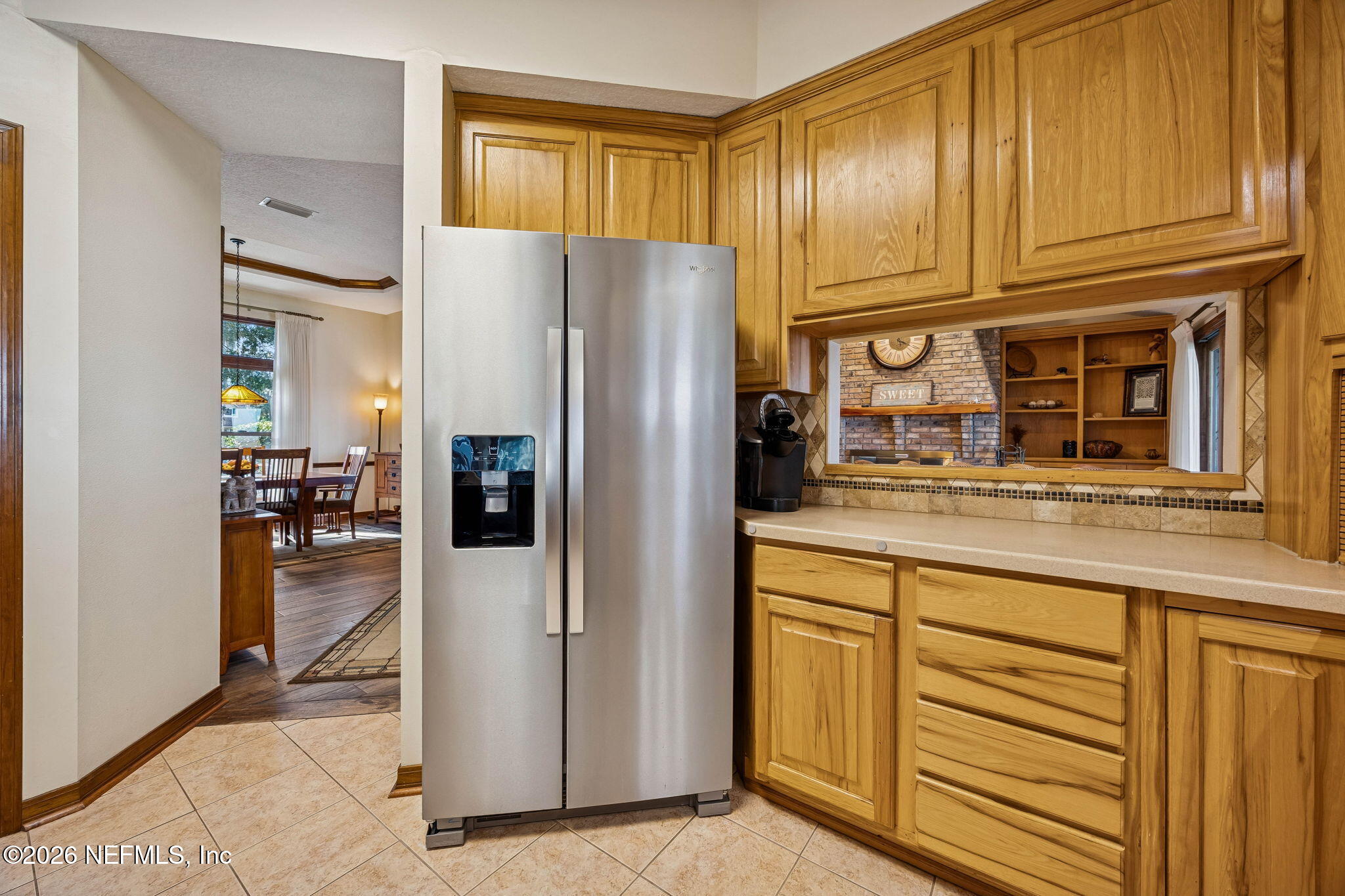 97146 Pirates Point Road Yulee, FL 32097 - Photo 20 of 74 a kitchen with granite countertop stainless steel appliances a refrigerator and cabinets