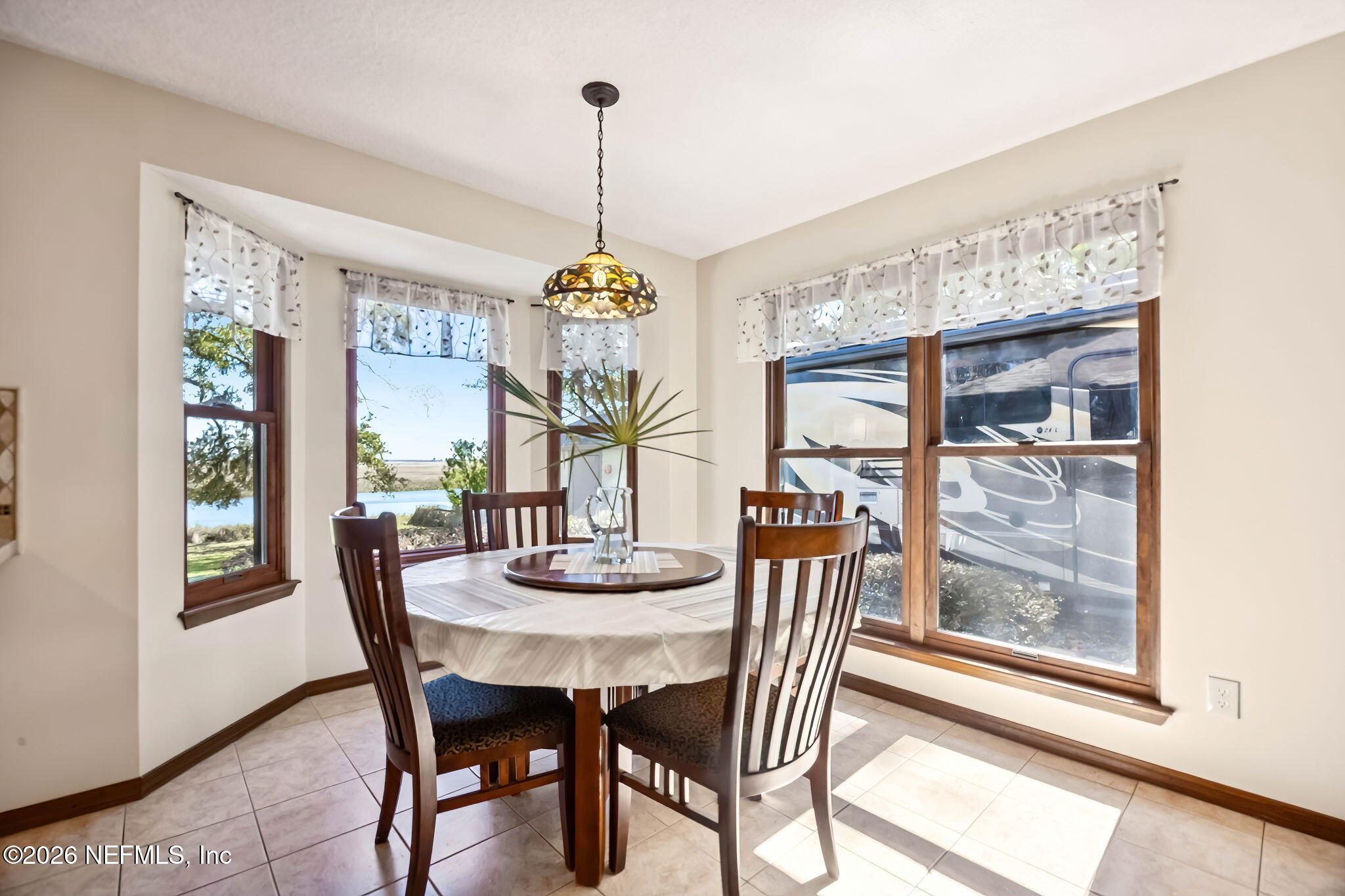 97146 Pirates Point Road Yulee, FL 32097 - Photo 22 of 74 a dining room with furniture a chandelier and wooden floor