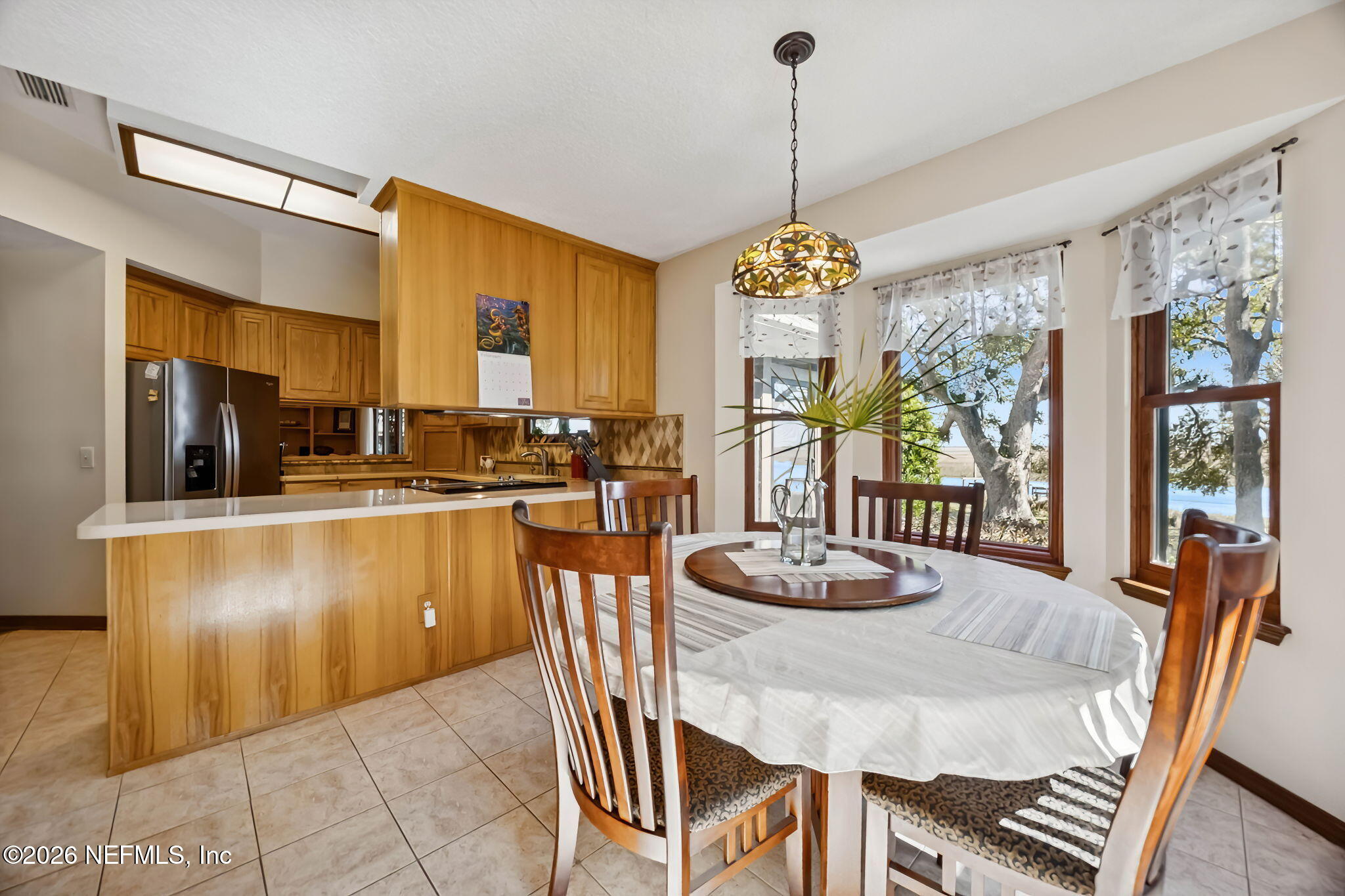 97146 Pirates Point Road Yulee, FL 32097 - Photo 24 of 74 a dining room with stainless steel appliances granite countertop a couch a table and chairs