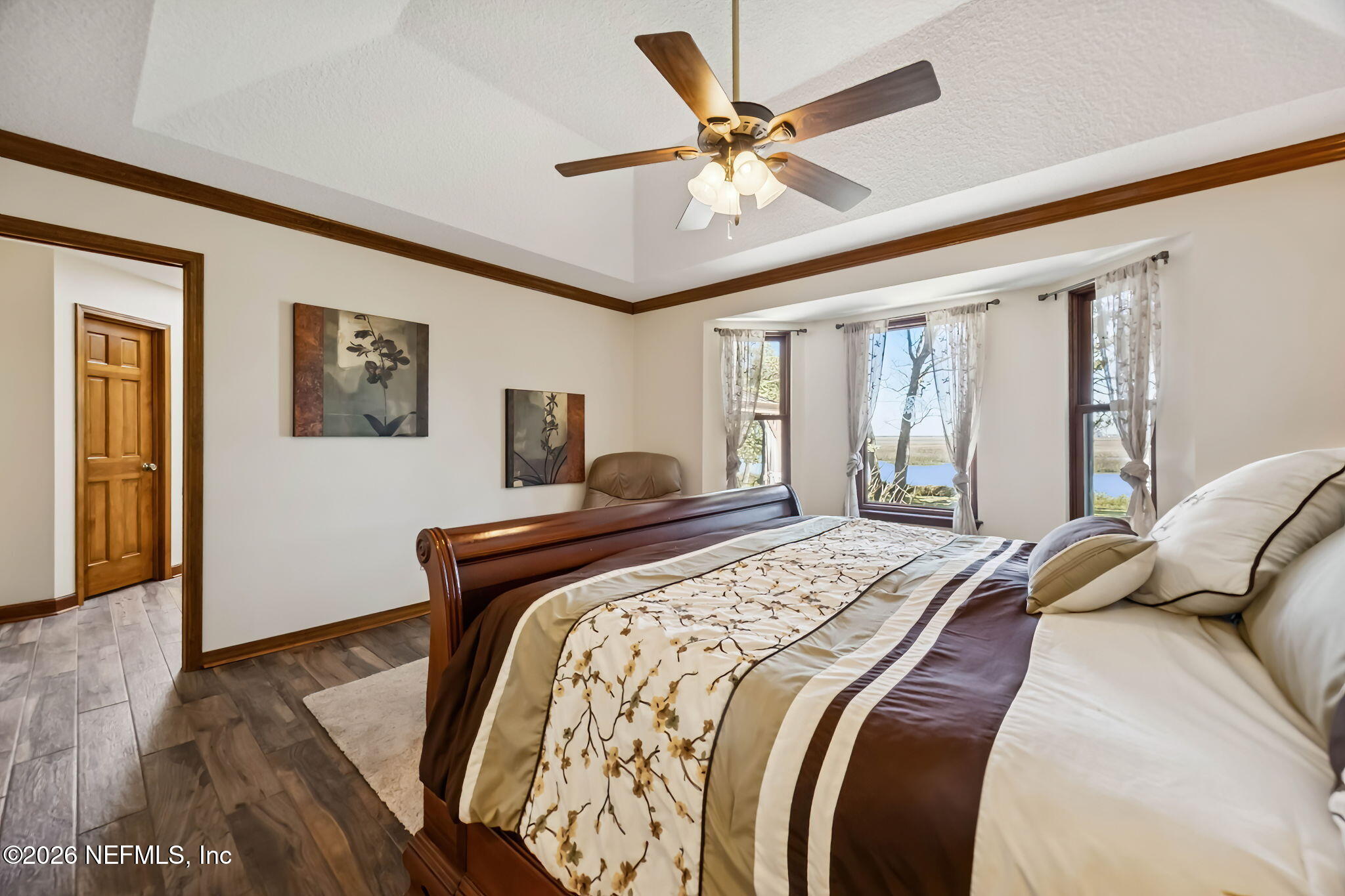 97146 Pirates Point Road Yulee, FL 32097 - Photo 25 of 74 a bedroom with a large bed and a window