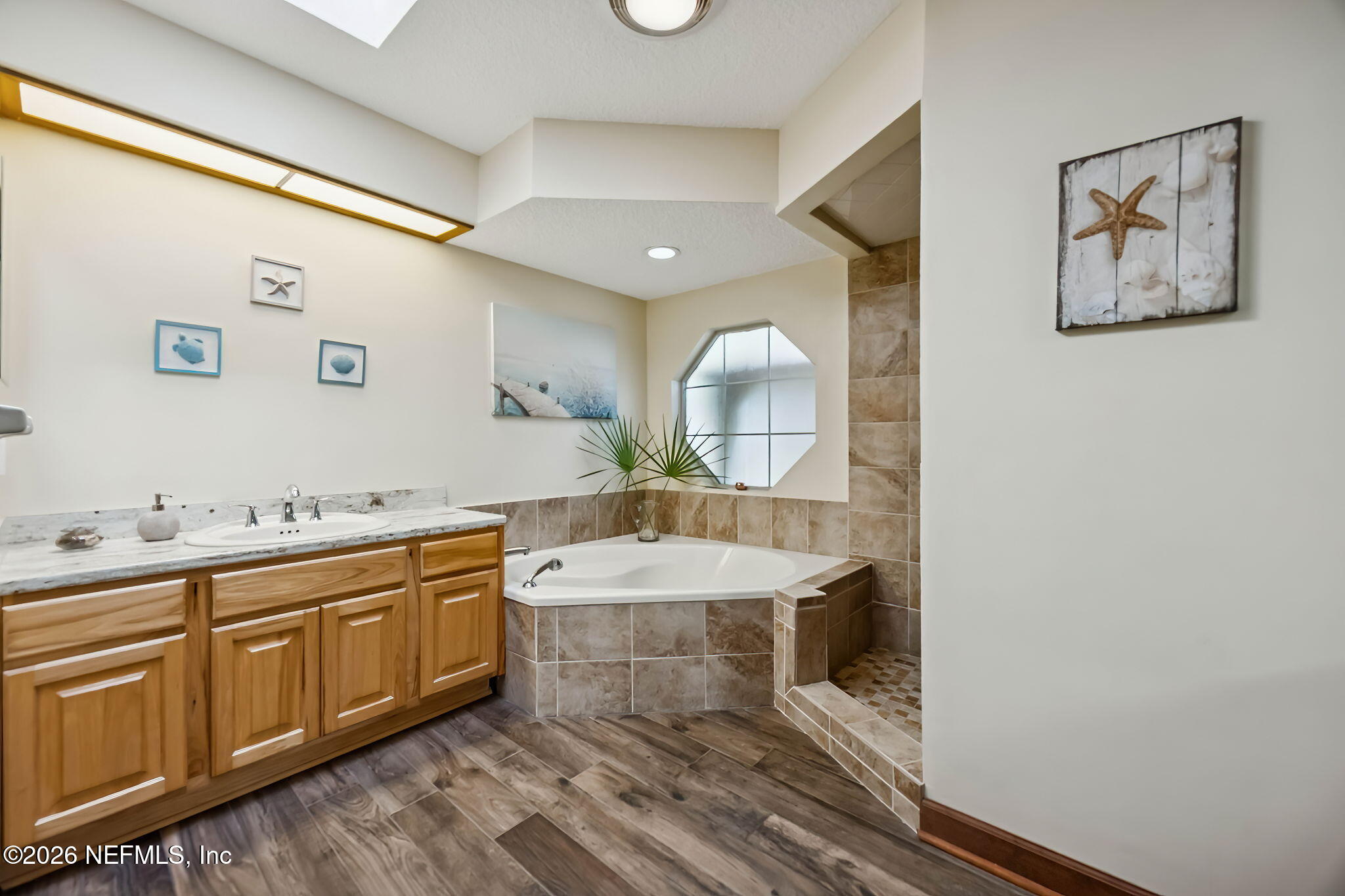 97146 Pirates Point Road Yulee, FL 32097 - Photo 27 of 74 a spacious bathroom with a granite countertop sink and a mirror