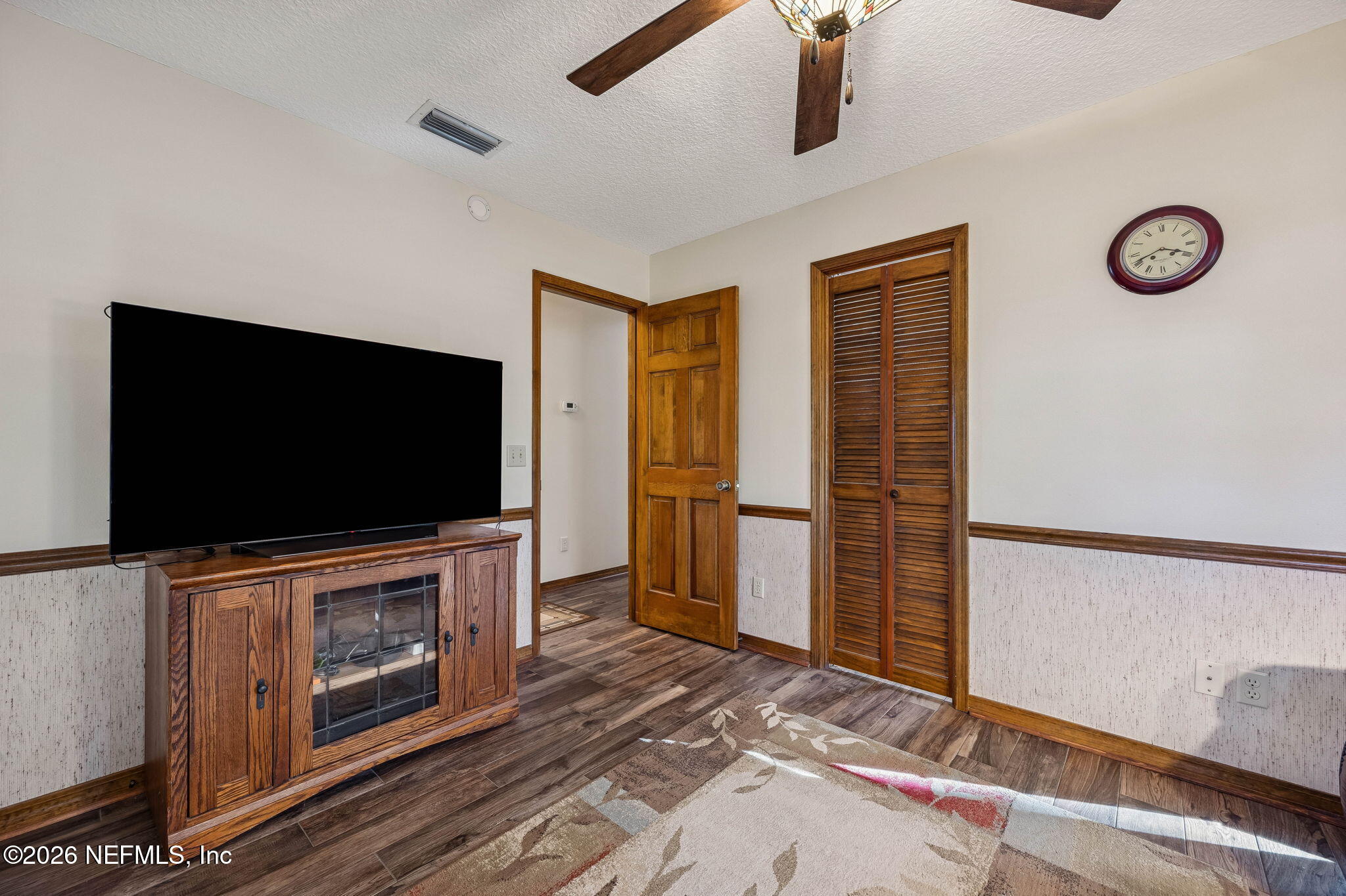 97146 Pirates Point Road Yulee, FL 32097 - Photo 32 of 74 a living room with furniture and a flat screen tv