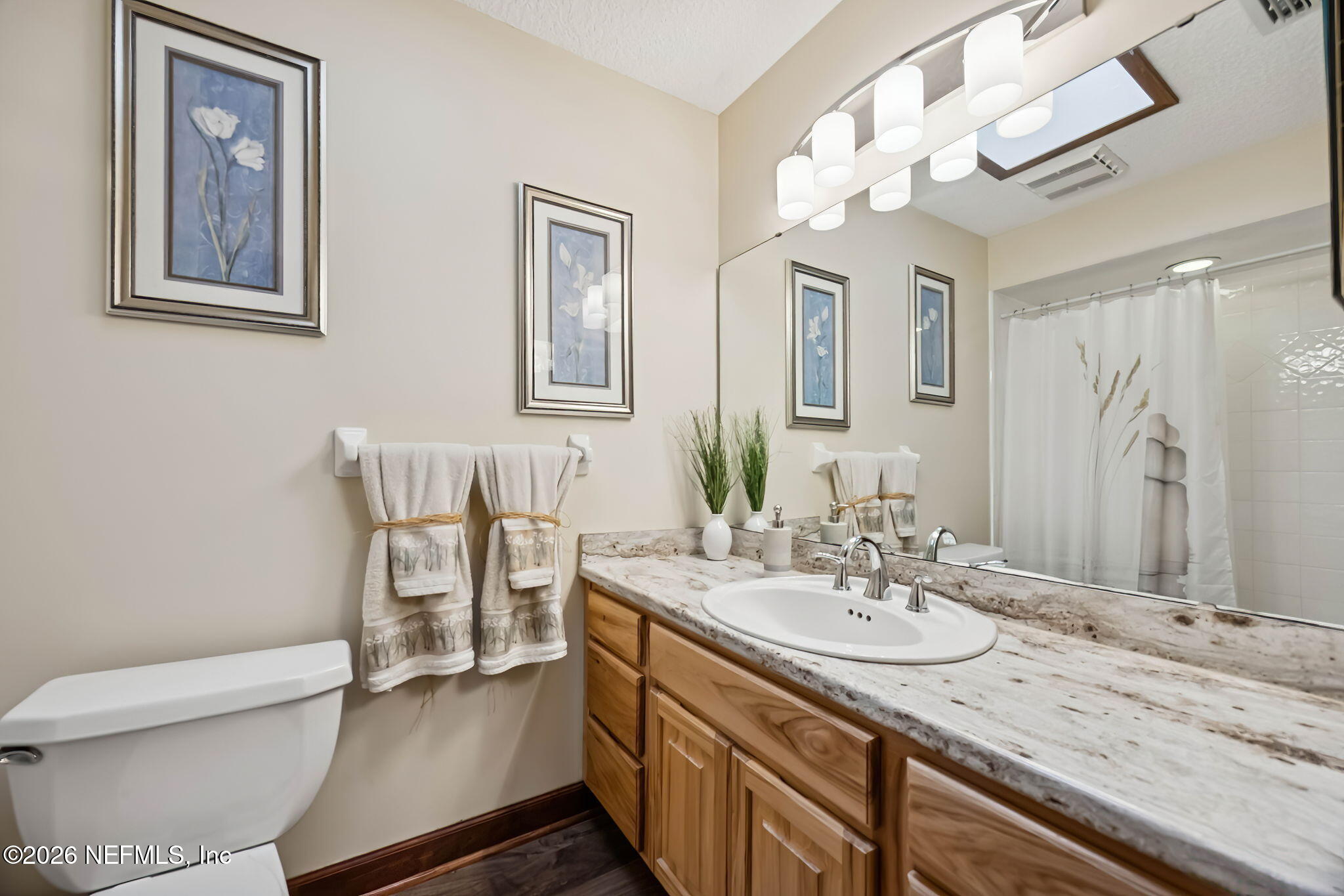 97146 Pirates Point Road Yulee, FL 32097 - Photo 33 of 74 a bathroom with a granite countertop sink a toilet and a mirror
