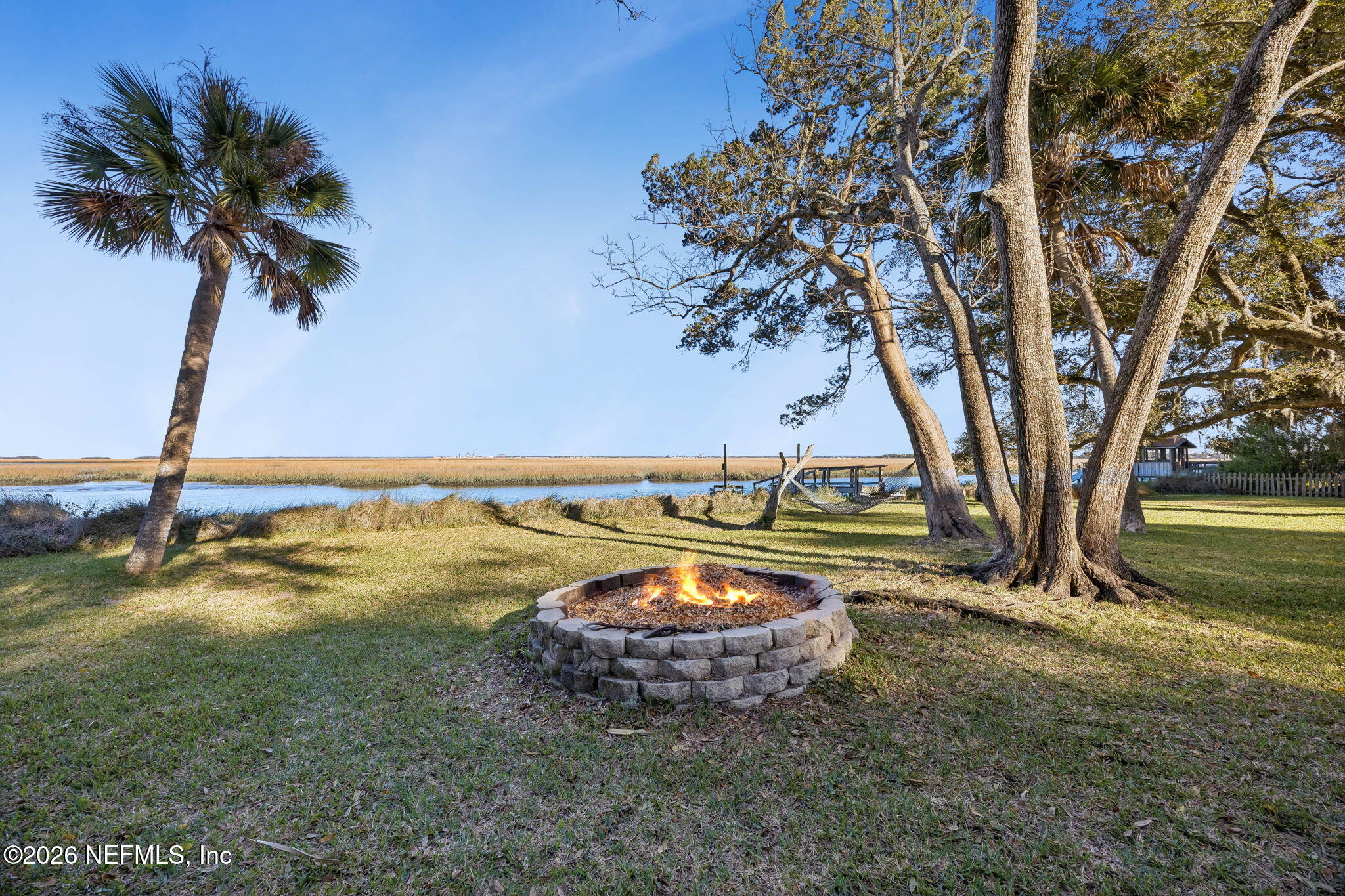 97146 Pirates Point Road Yulee, FL 32097 - Photo 47 of 74 a view of a backyard with a table and chairs under an tree