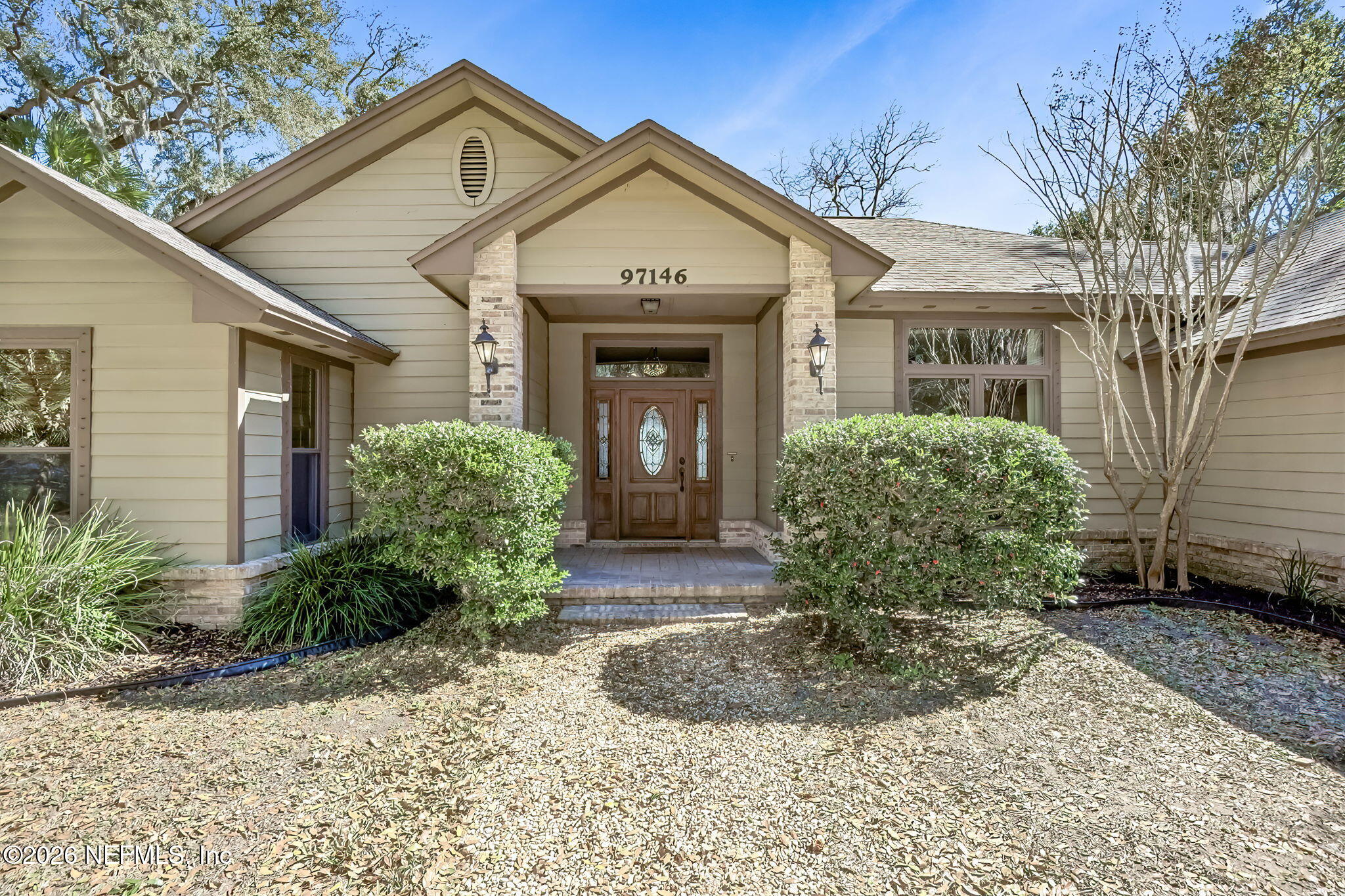 97146 Pirates Point Road Yulee, FL 32097 - Photo 7 of 74 a front view of a house with garden