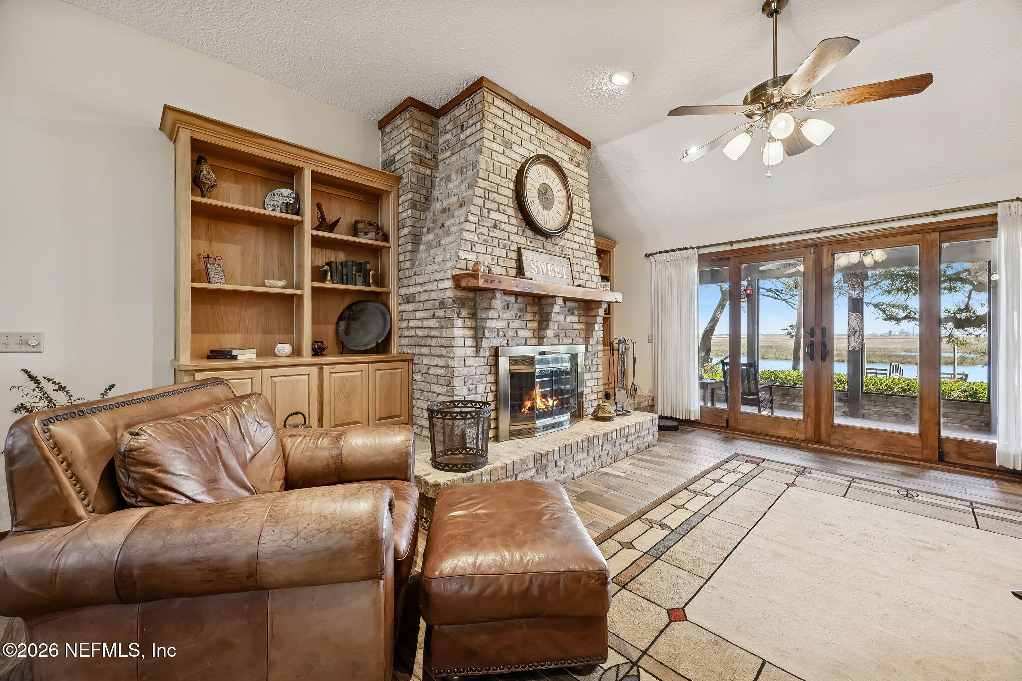 97146 Pirates Point Road Yulee, FL 32097 - Photo 9 of 74 a living room with furniture fireplace and a large window