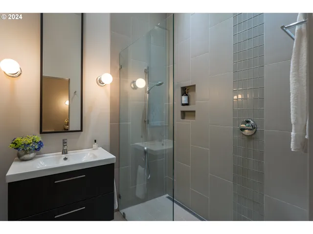 a bathroom with a sink vanity and a mirror