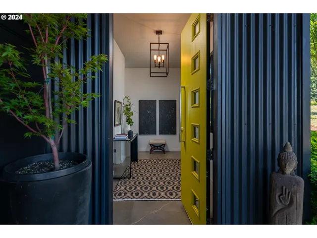 a kitchen with stainless steel appliances granite countertop a refrigerator a sink dishwasher a stove and a refrigerator with wooden floor