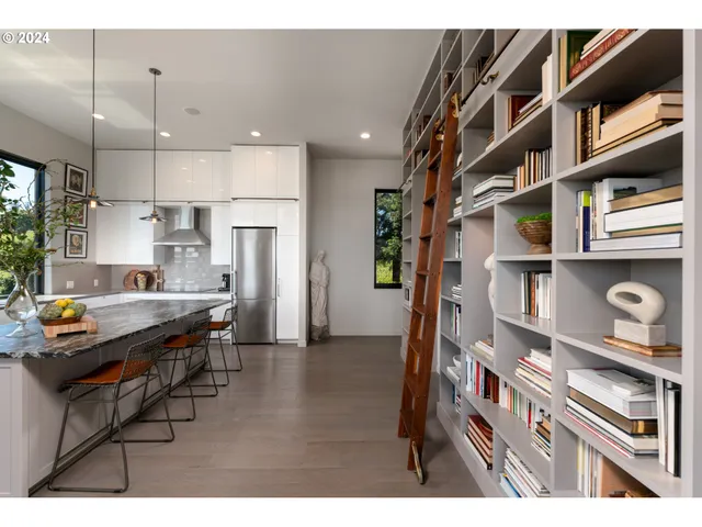 a open kitchen with granite countertop a sink and a refrigerator