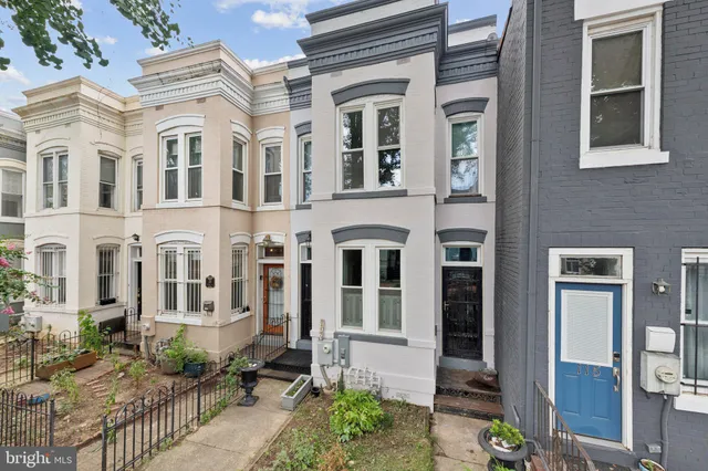 a view of a brick building next to a yard
