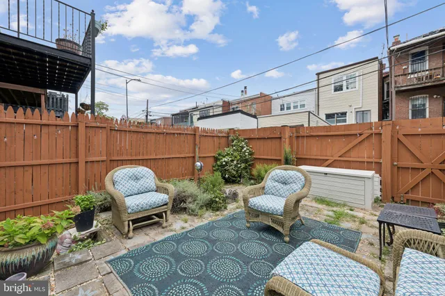 a kitchen with white cabinets and appliances