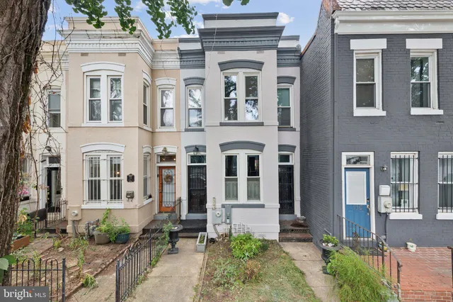 a spacious bedroom with a bed couch and a window