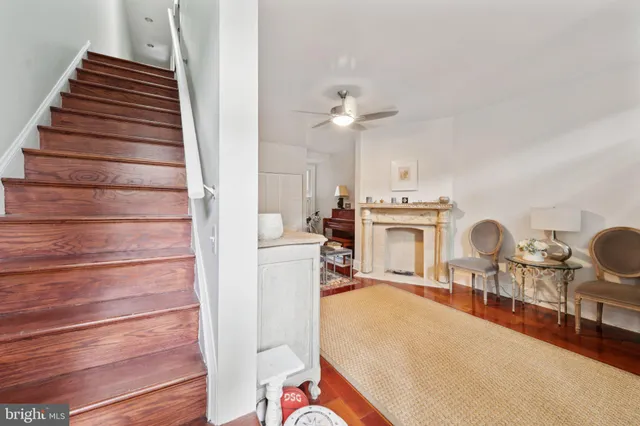 a living room with furniture a fireplace and white walls